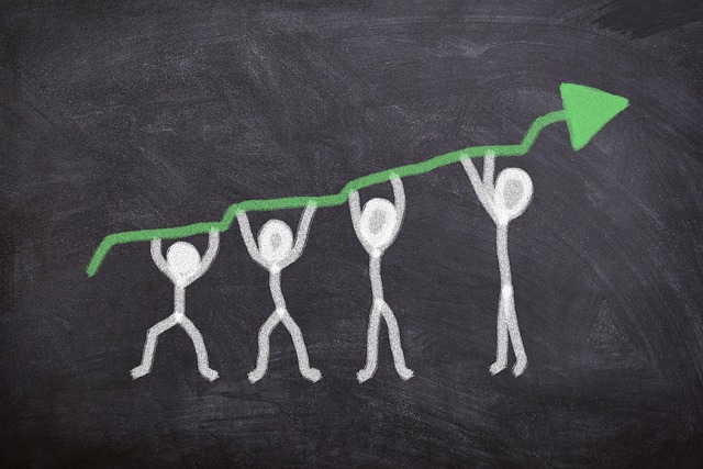 Picture of stick men holding up an arrow that's showing growth