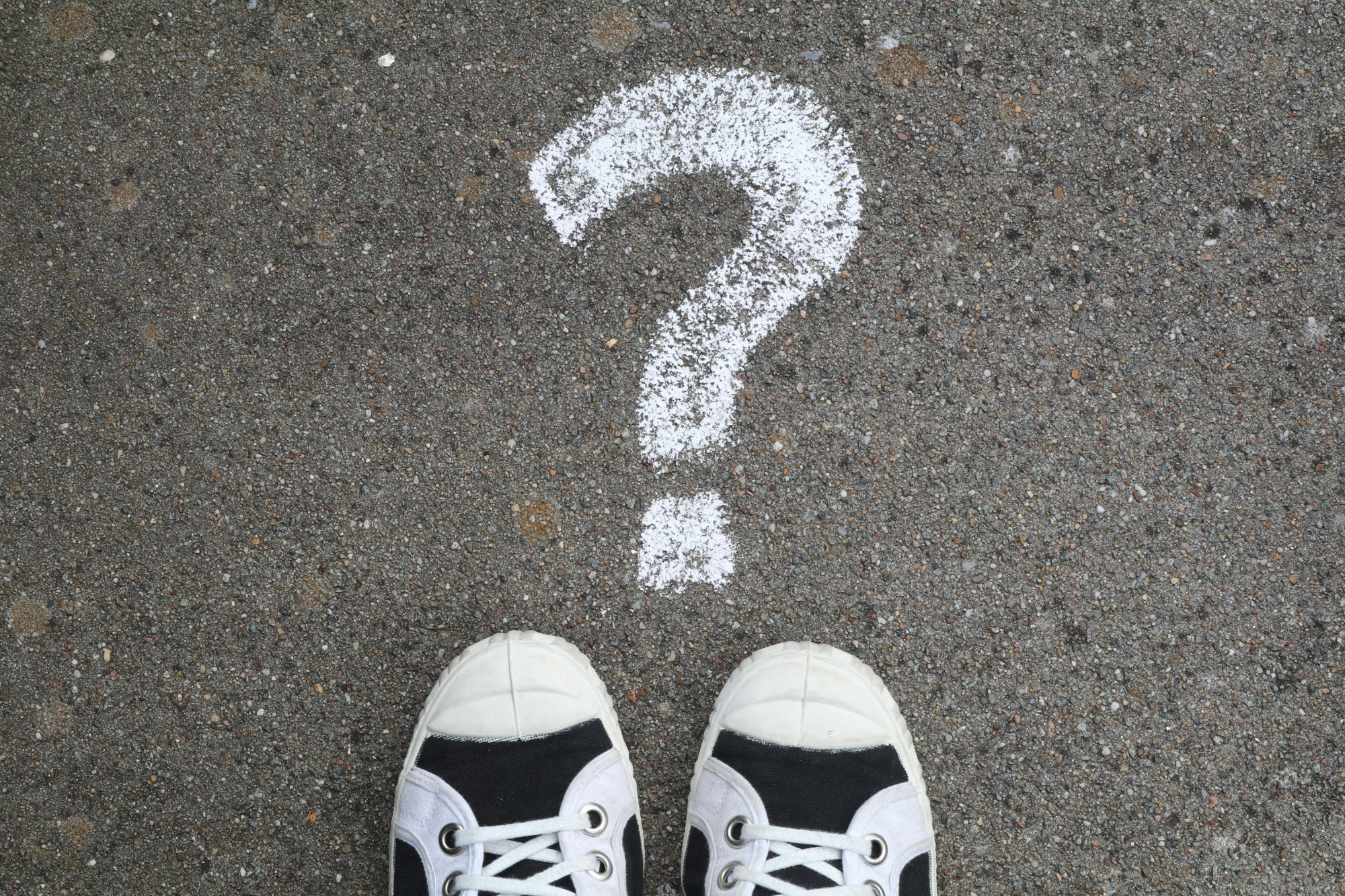 ? written in chalk in front of two feet on the ground