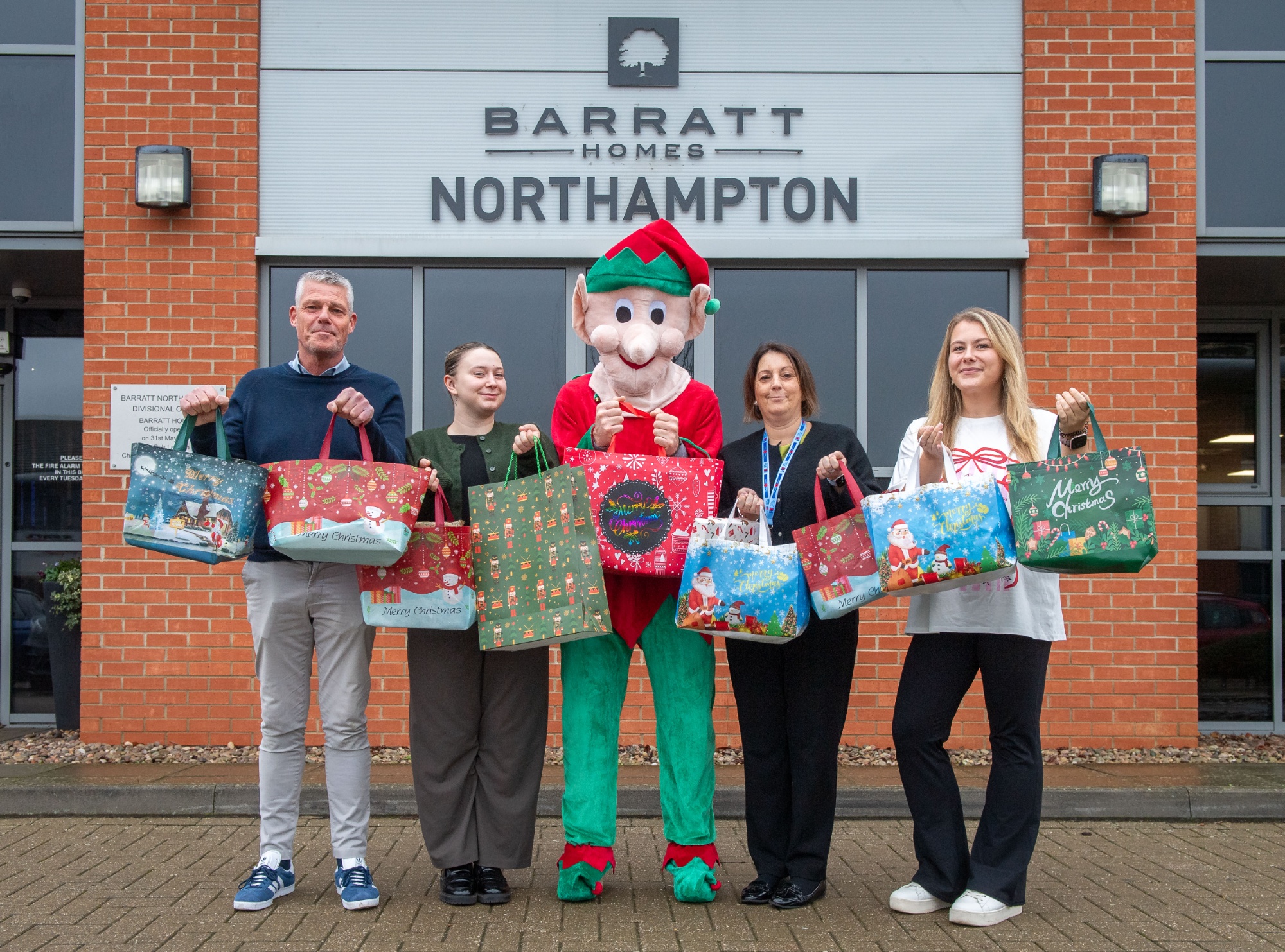 Staff from Barratt Homes Northampton on their way to deliver presents for Kings Meadow's Father Christmas visit.